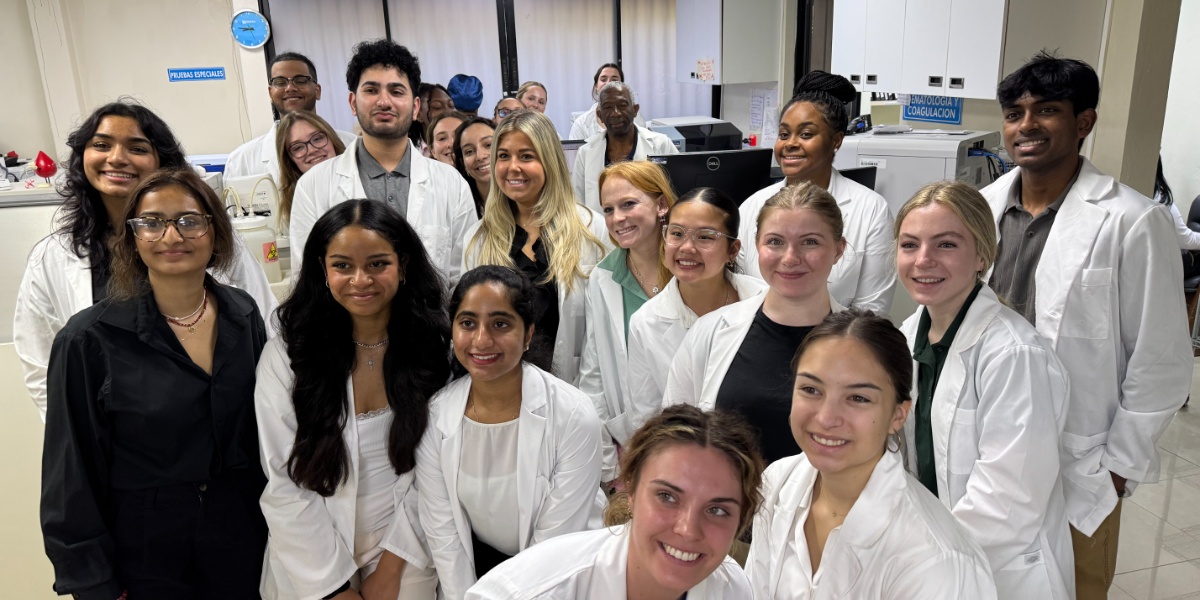 Michigan State University students taking a group photo in a hospital reception area.