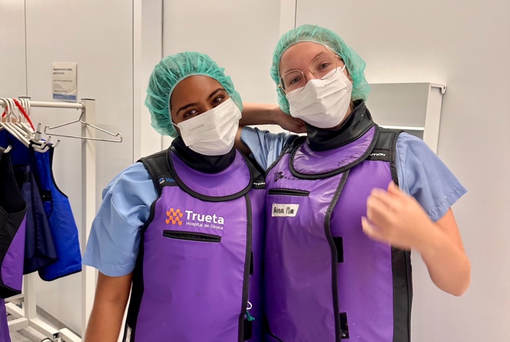 Manushree Ganta and a member of her cohort in surgical gear during a hospital surgery observation.