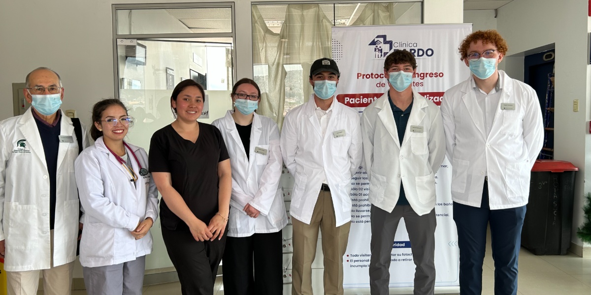 MSU students in lab coats getting ready for rotations at Clinica Pardo in Cusco, Peru.