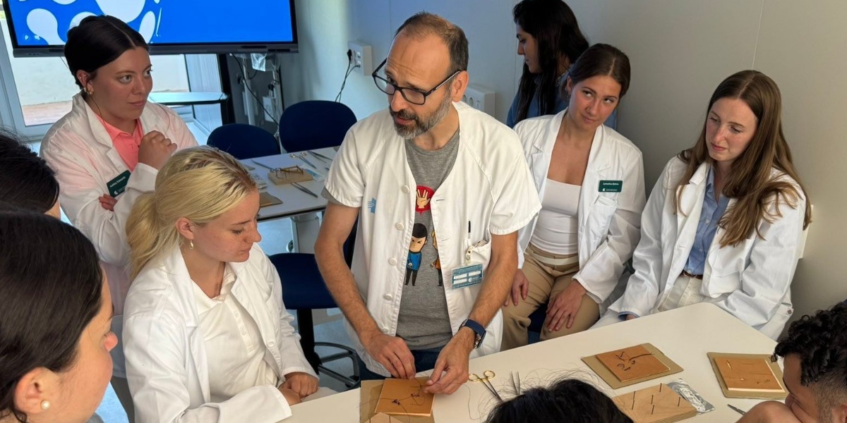 MSU students watching a physician give an example of proper suturing techniques.