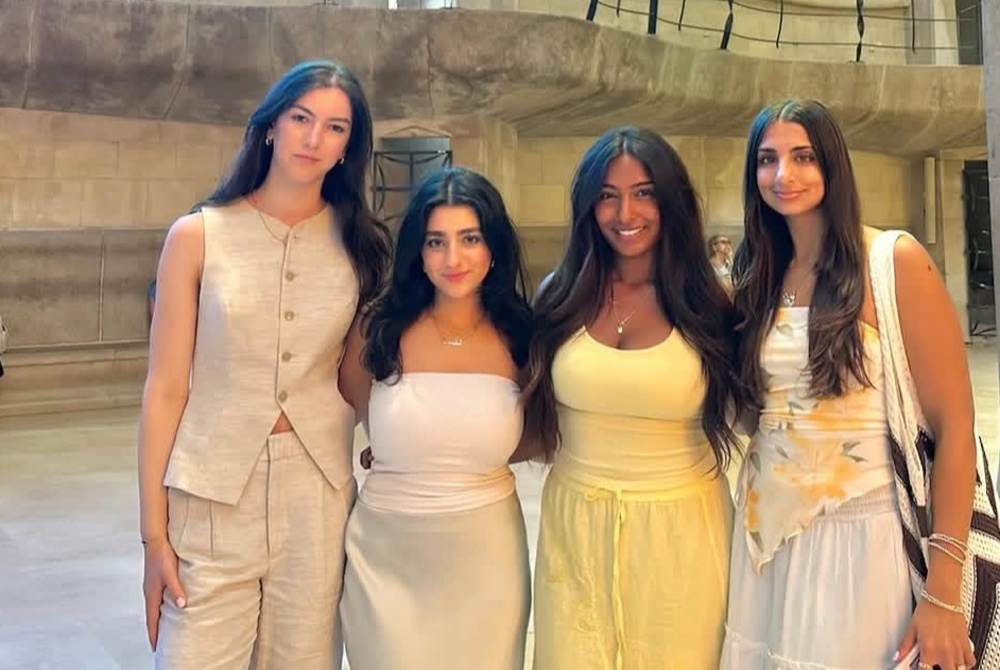 Manushree Ganta standing with friends inside the Sagrada Familia Cathedral in Barcelona, Spain
