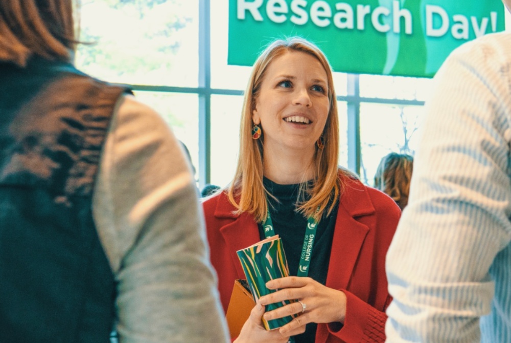 MSU College of Nursing Professor Dr. Courtney Sullivan talking with guests at the College of Nursing Research Day