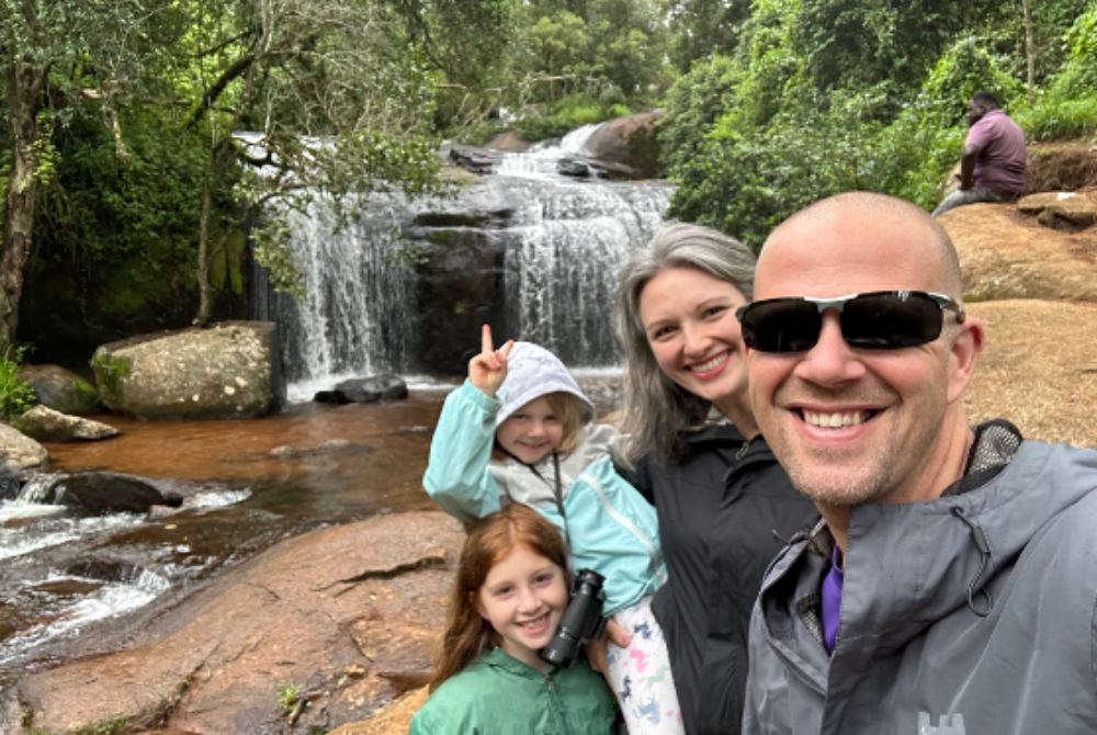Dr. Bryan Vonasek with his wife and two daughters in front of a waterfall