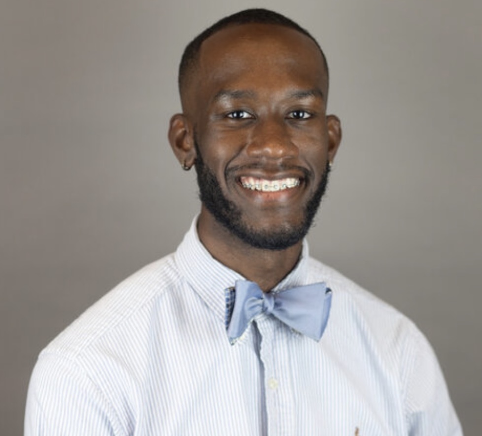 dee Dubose in a white dress shirt and light blue bowtie.