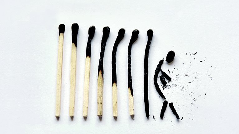 A series of match sticks that go from slightly burned on the left to completely burnt and broken on the far right.