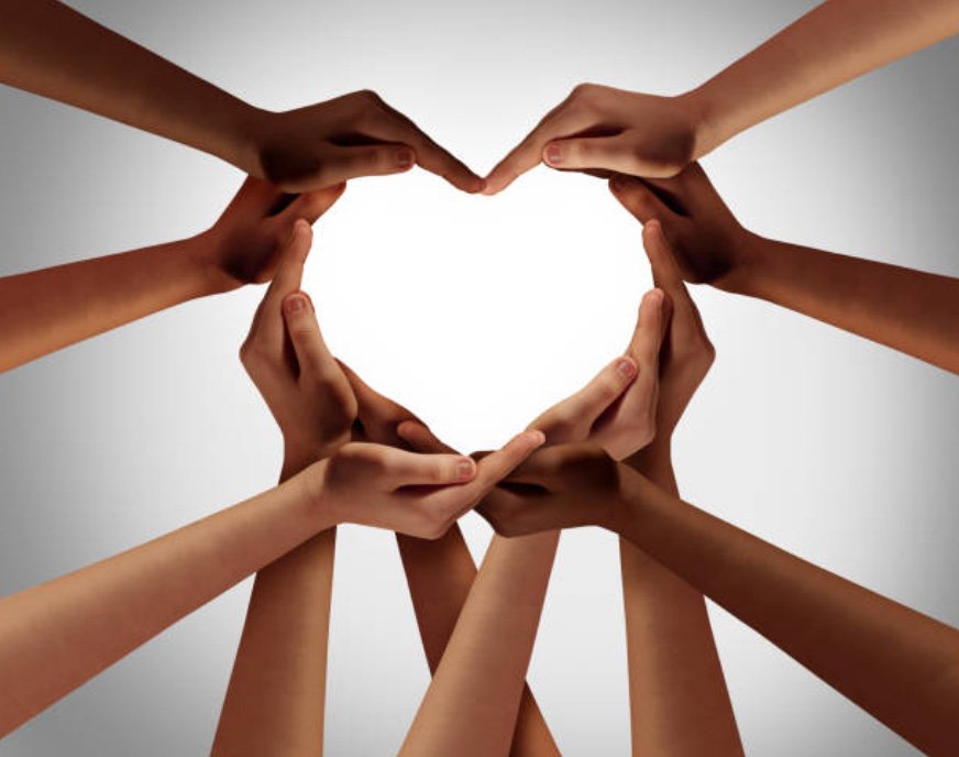 Multiple hands are interconnected in a way that shows a heart.