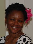 Lami in black and white dress with a red bow in her hair.