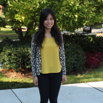 Carrie Li standing outside in a yellow shirt.