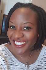 Molade in a white shirt and wearing a necklace.