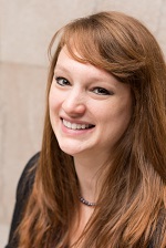 Caitlyn Cornell smiling in a black shirt.