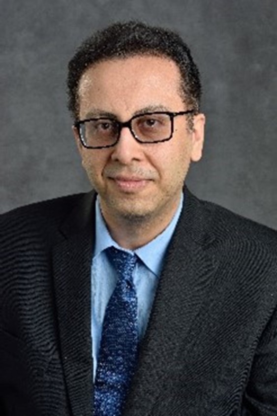 Amirpouyan Nejadhashemi in a black suit, blue shirt, and blue tie.