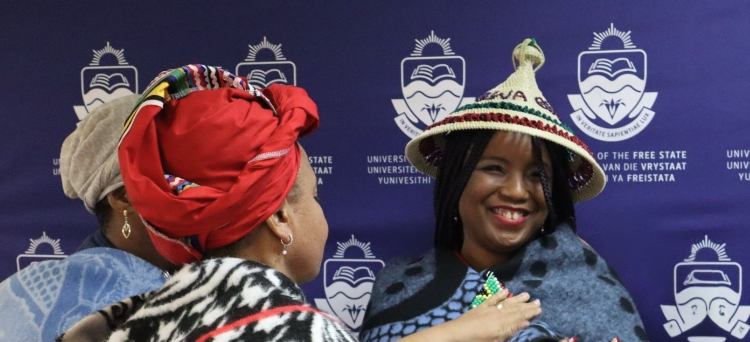 Professor Nwando Achebe being welcomed with a sotho hat and blanket and given the name Masechaba during her Africa Day Memorial Lecture.
