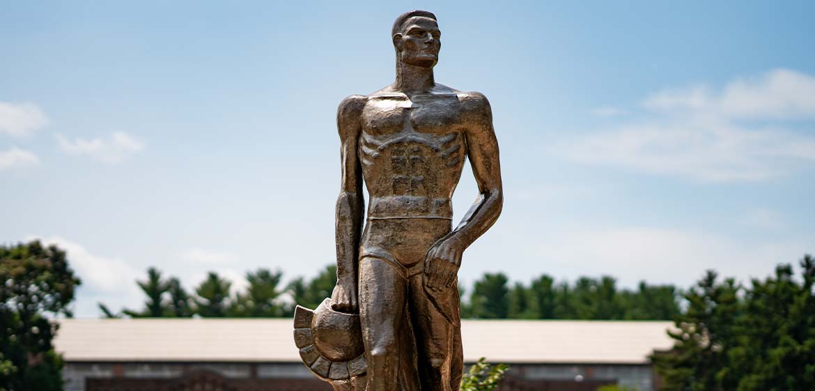 The Spartan statue stands tall on a sunny, summer day. 