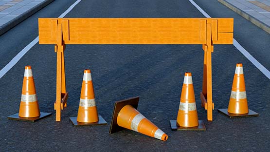 Construction barricade and cones on a road lane