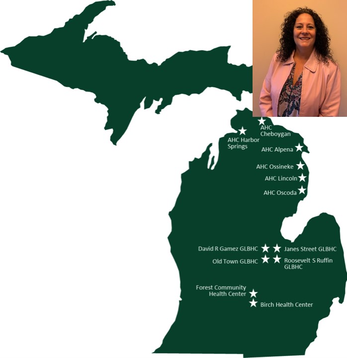 This image depicts a map of Michigan set against a white background, shaded in Spartan green. Across the map, several star symbols are distributed, marking various clinic locations. The clinics indicated include AHC Harbor Springs, AHC Cheboygan, AHC Alpena, AHC Ossineke, AHC Lincoln, AHC Oscoda, David R Games GLBHC, Old Town GLBHC, Janes Street GLBHC, Roosevelt S Ruffin GLBHC, Forest Community Health Center, and Birch Health Center. Each star symbol is shaded in white, of the same size, and serves to denote a distinct clinic location within the state.  Image of Sandy Samp top left. 