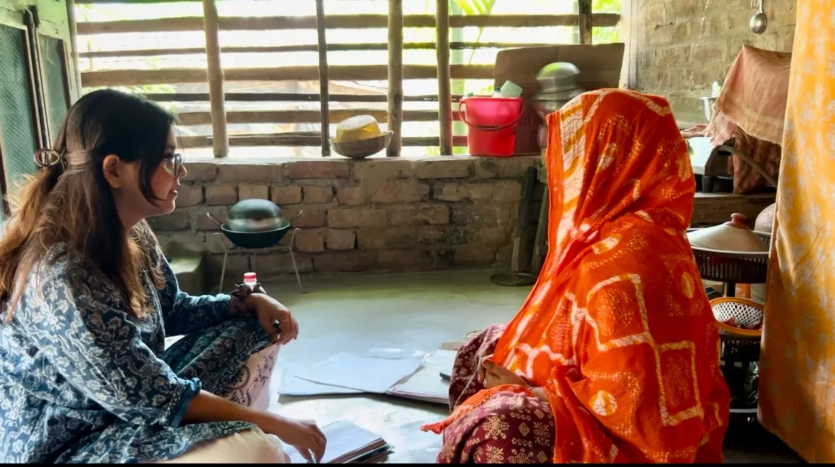 two women sit on the floor and talk