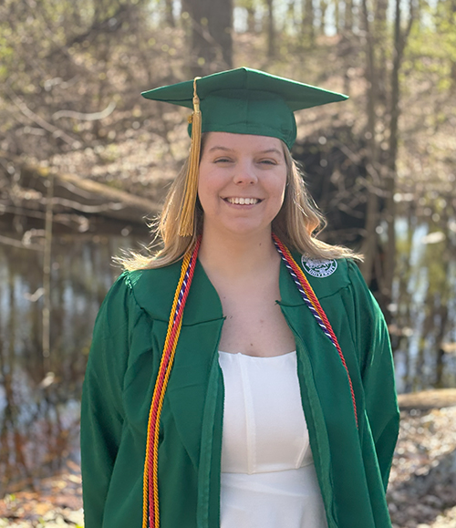 Photo of Liz Armstrong in a green cap and gown