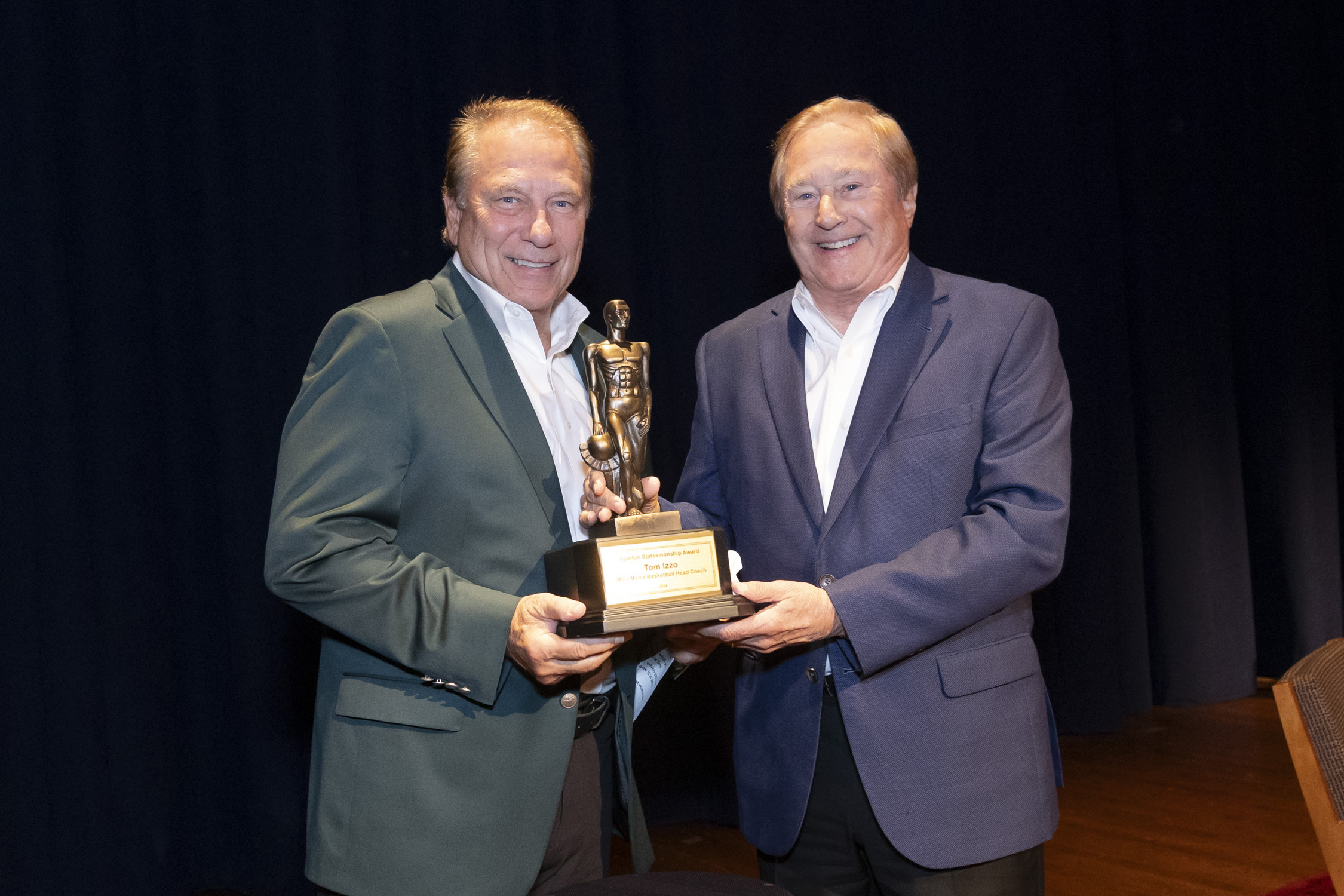 Tom Izzo and Jim Blanchard posing for a photo holding sparty trophy