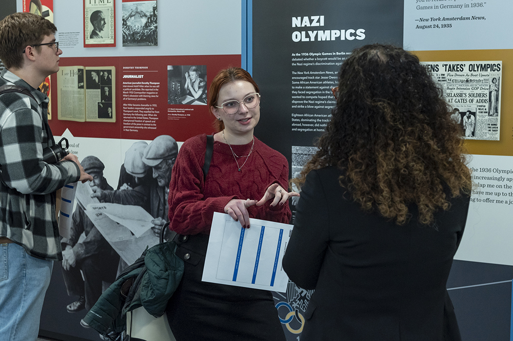 Dr. Kirsten Fermaglich, a professor of history and Jewish Studies at MSU talks with a student in front of a museum exhibit
