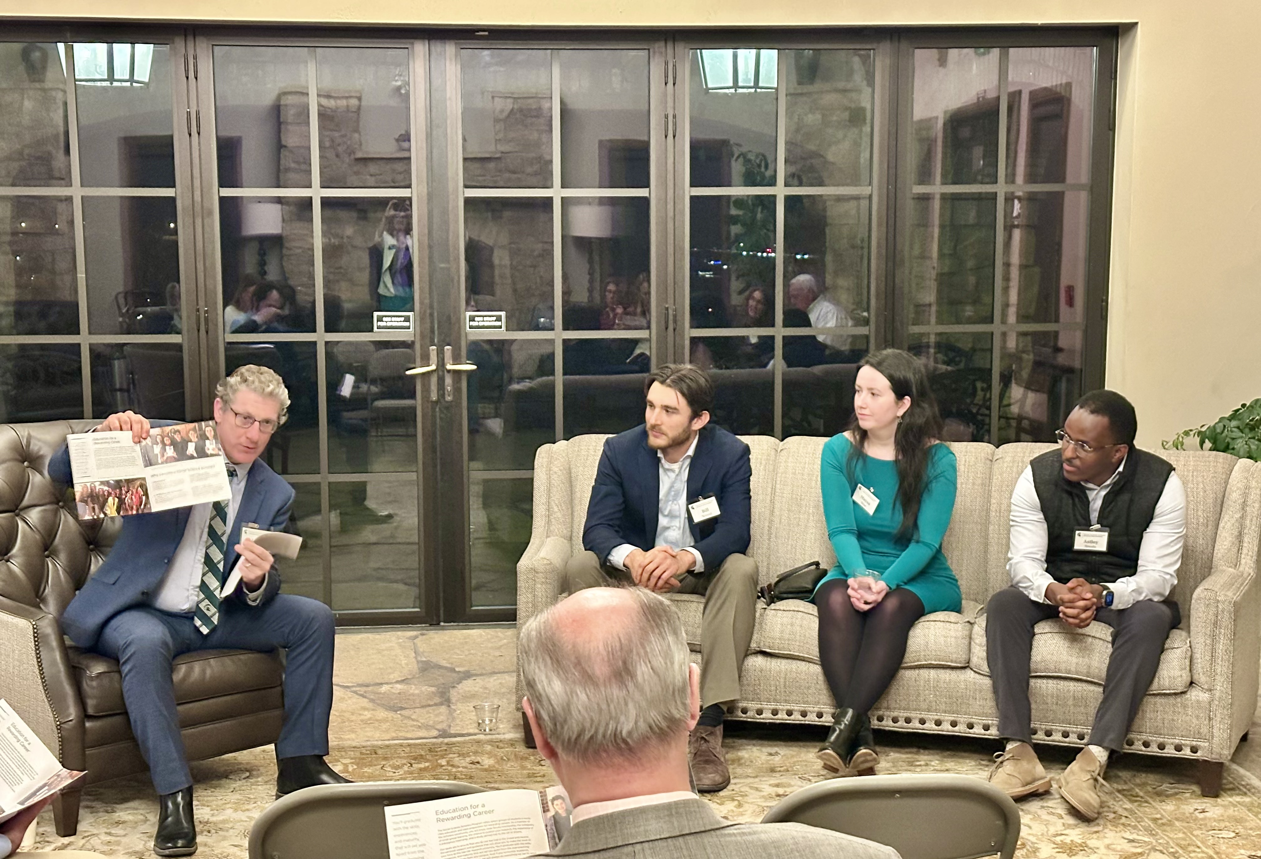 Alumni and Scholars sit on a couch having a conversation