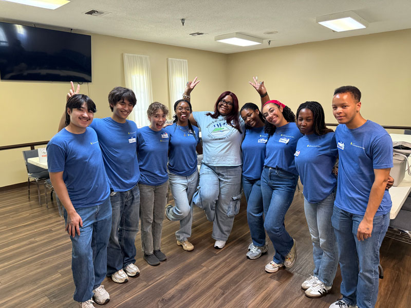 Angelique Willis poses with a group of students.