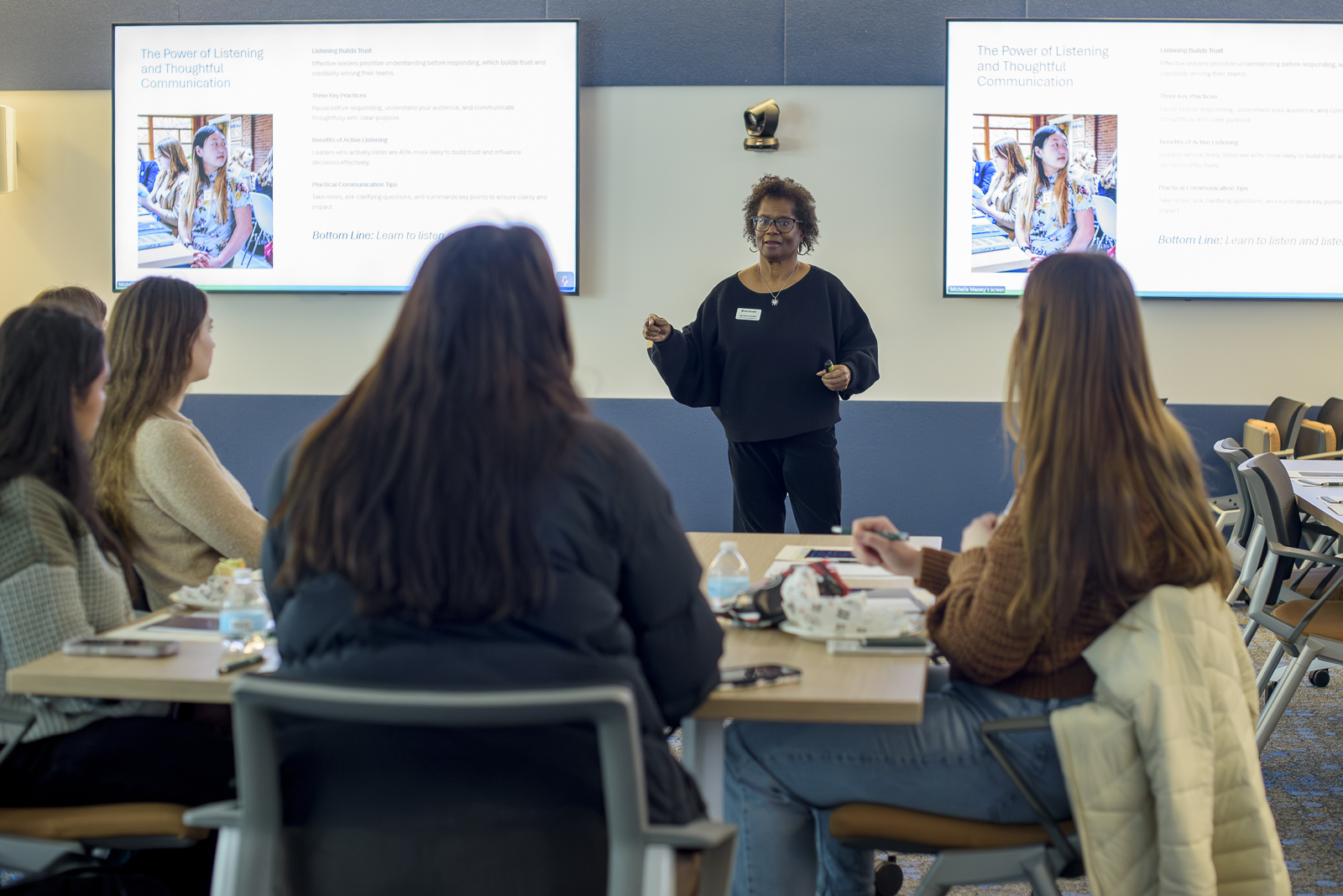 Michelle Massey speaks to people in a meeting.