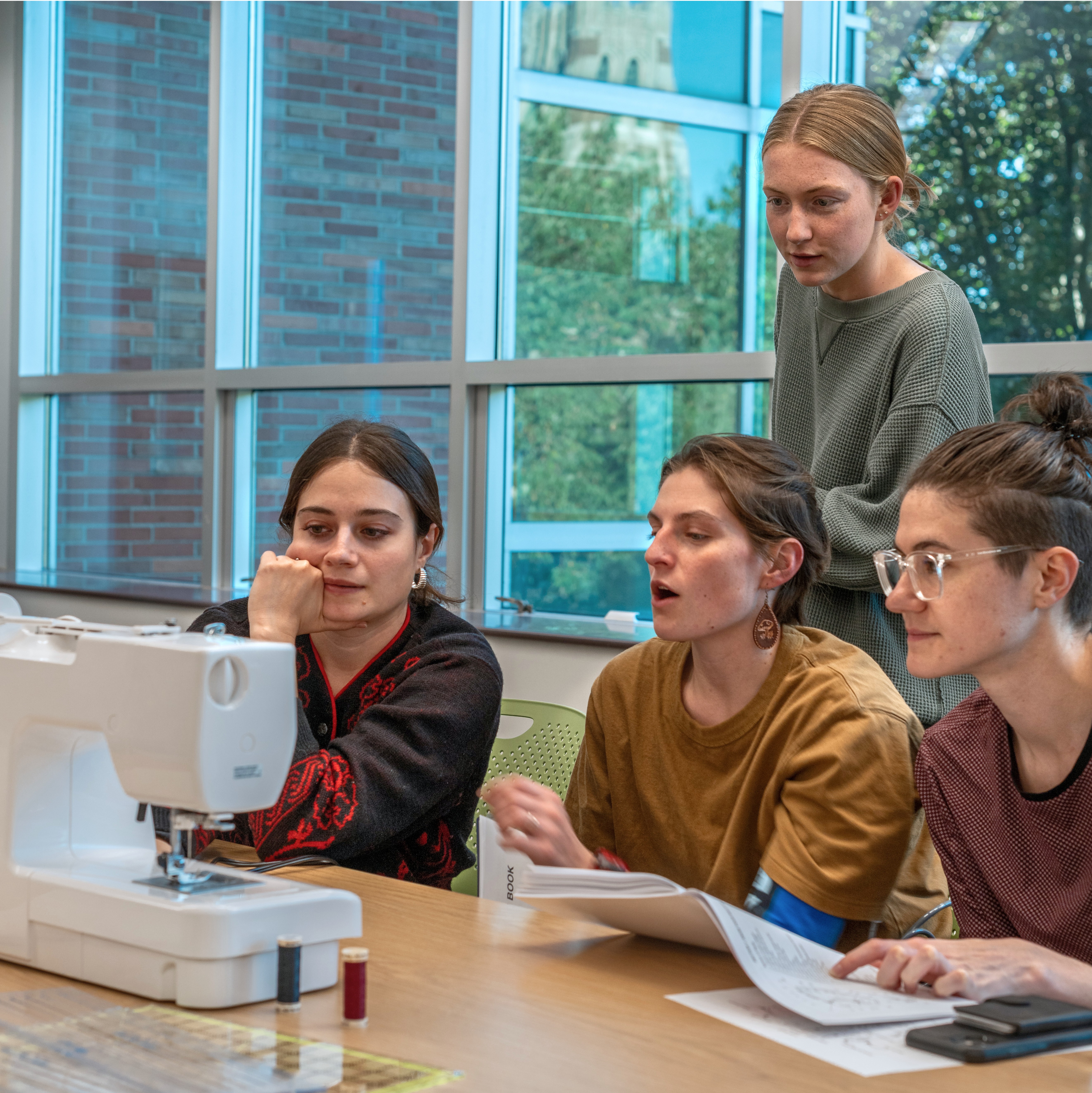 Group of students using sewing machine
