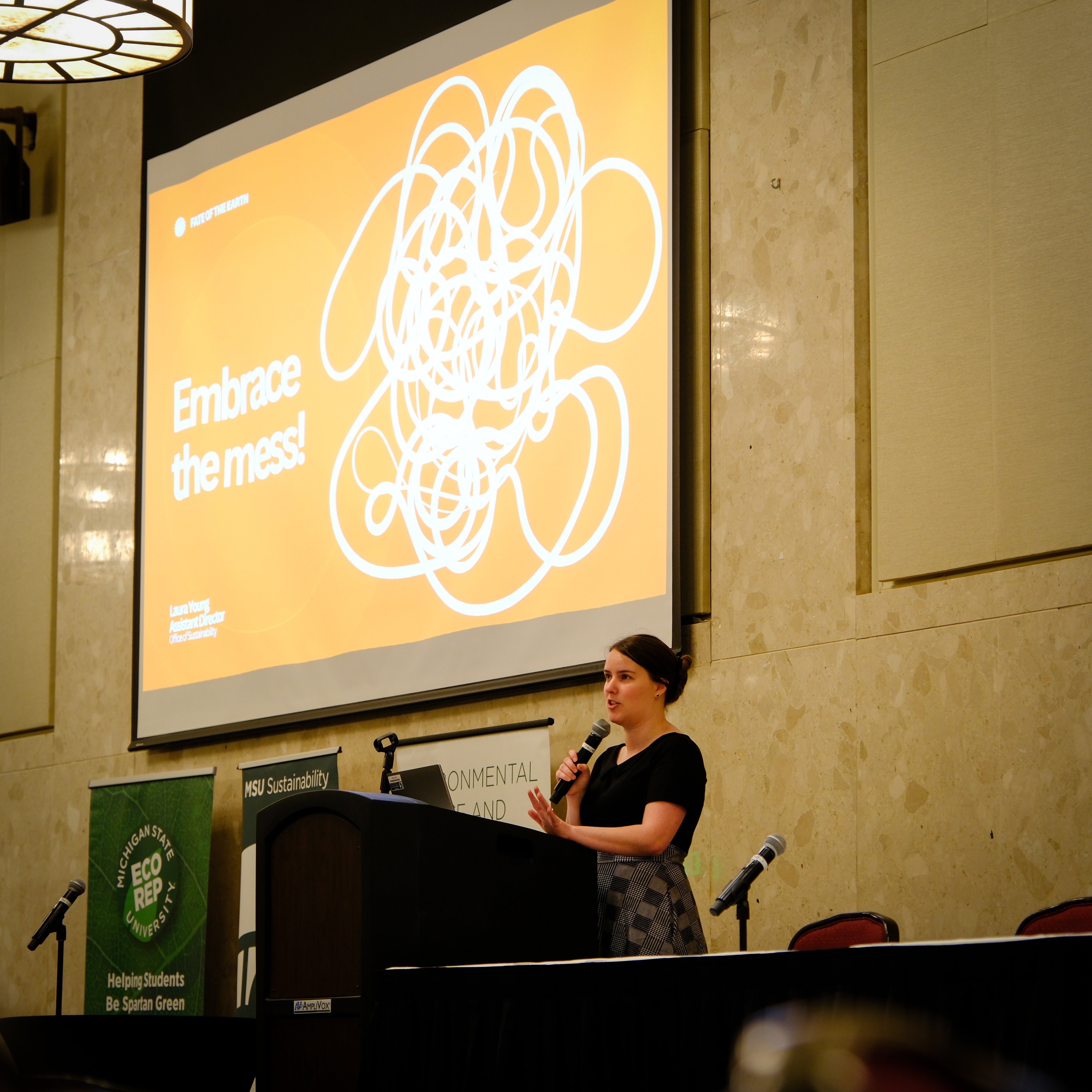 Laura Young presenting on stage