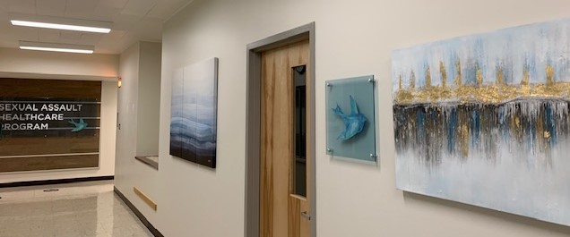 Hallway with Center for Survivors Blue Bird Icon, and other artwork inside Center For Survivors 