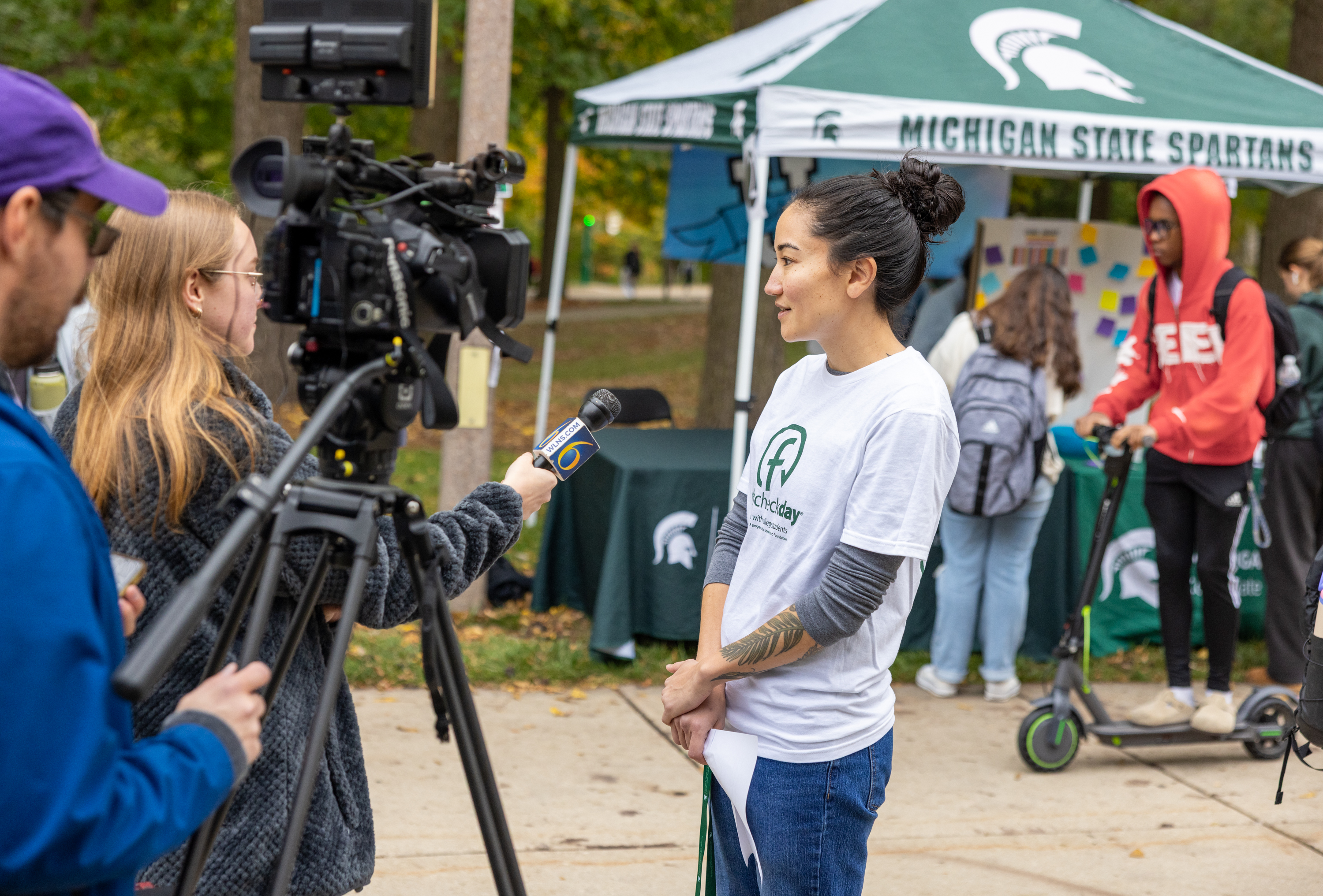 UHW staff member doing an interview with WLNS 6 at Fresh Check Day