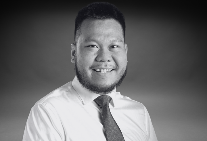 Black and white headshot of senior learning experience designer Tom Cheng.