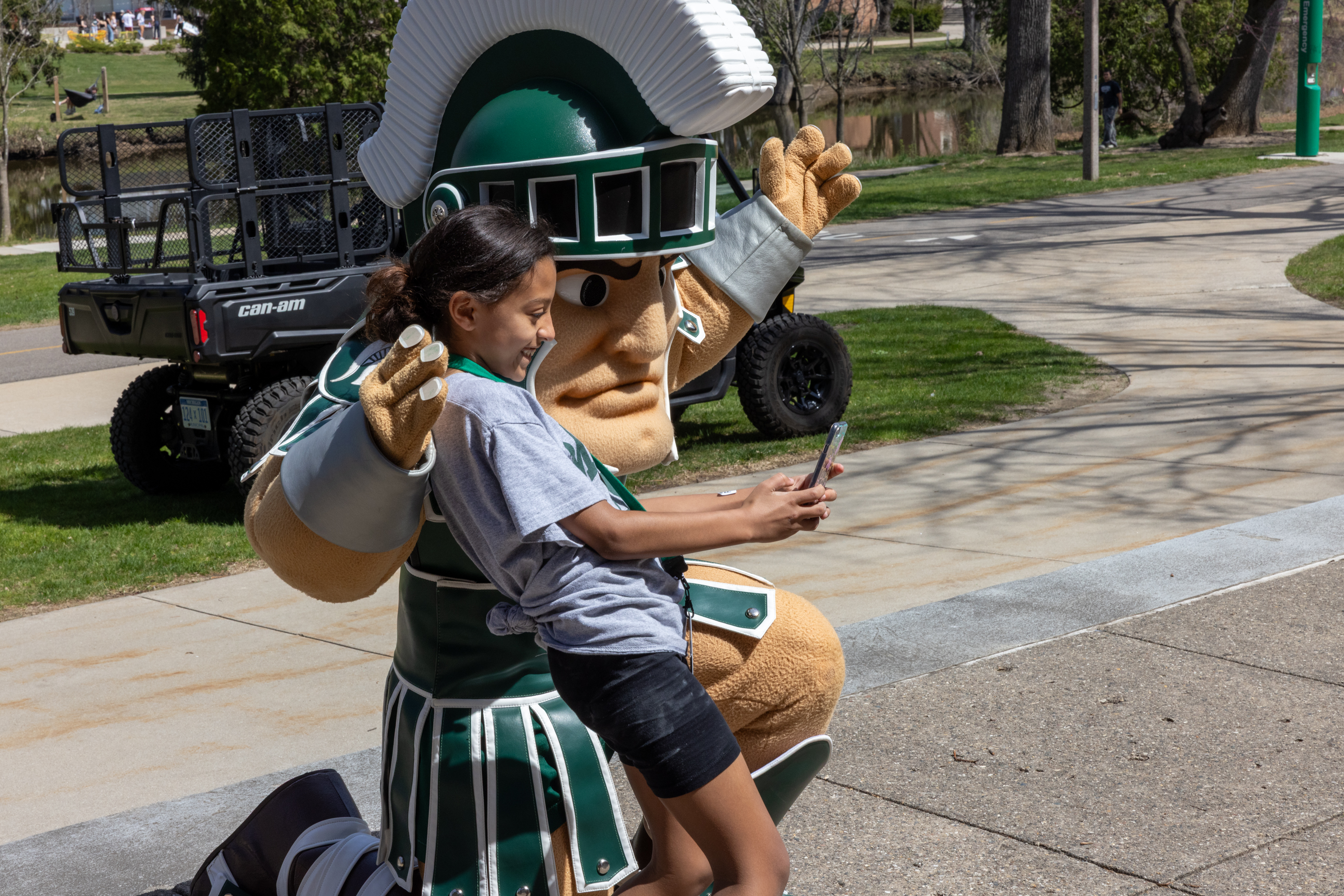 a child taking a photo with sparty