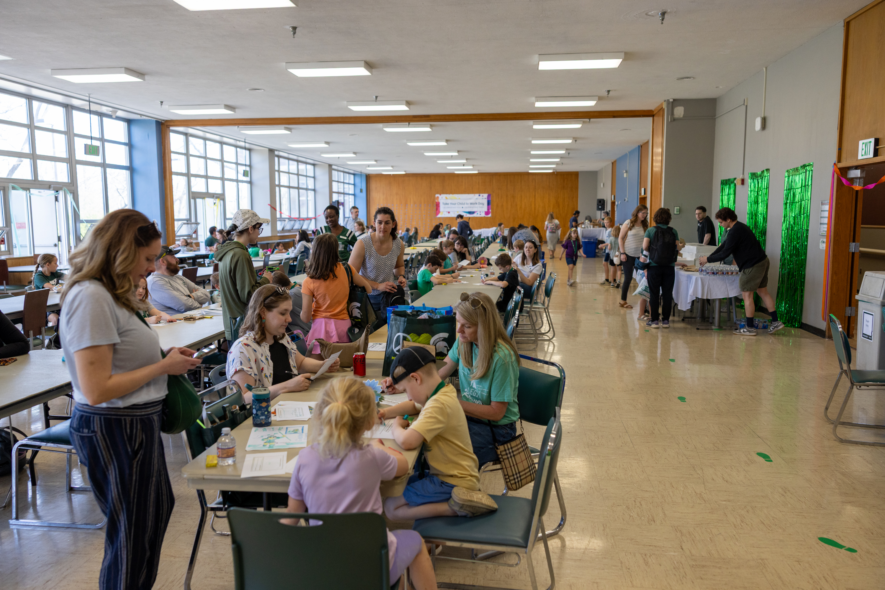 people sitting at tables during Take Your Child to Work Day