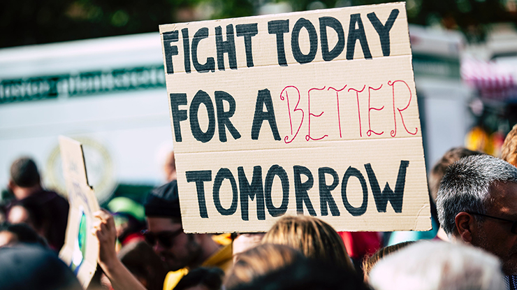 Learners interested in comparative politics gather in a protest ? one sign reads, ?Fight today for a better tomorrow.?