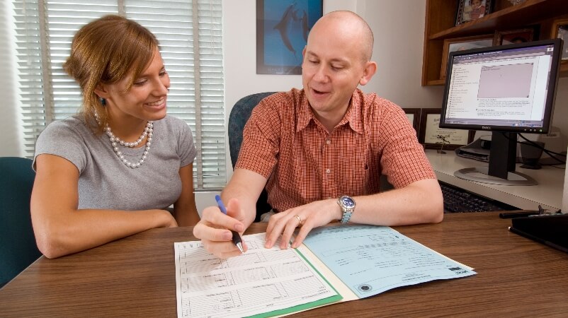 An undeclared major sits at a desk and consults with an academic adviser.