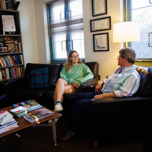 A residential college student at MSU meeting with an adviser in the residence hall where she lives and learns.