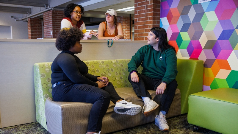 Residential college students at MSU hanging out together in their residence hall where they live an learn.