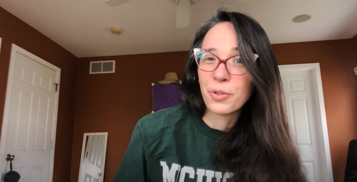 MSU student, Alexa, sitting in her room and giving her perspective on attending Michigan State University