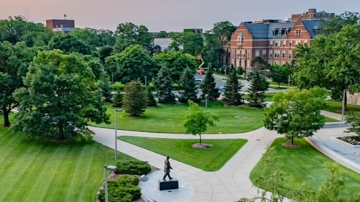 An aerial view of green trees and sidewalks in front of the Hannah Administration Building