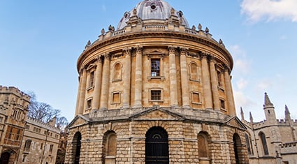 The Radcliffe Camera in Oxford, England, a grand neoclassical building with a domed roof and circular structure, part of the University of Oxford.
