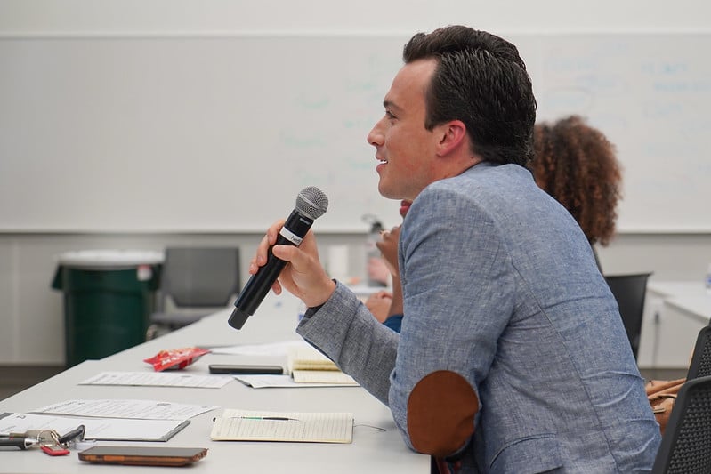Man speaking at judging table