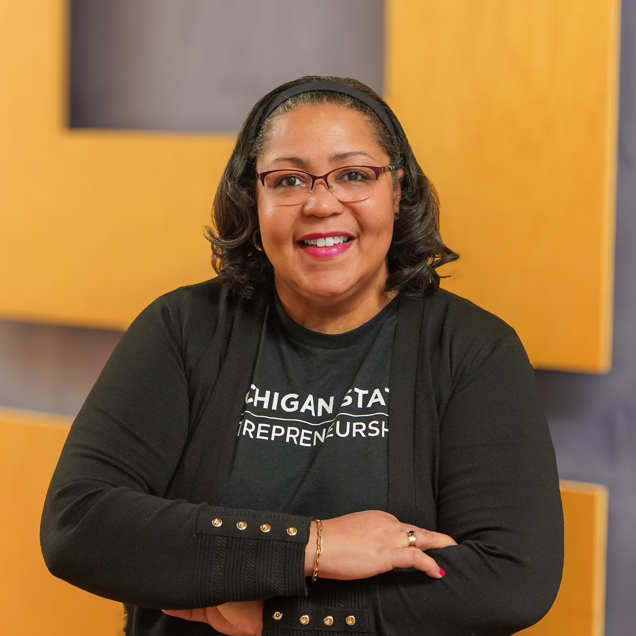 Lillian Brooks proudly wearing a black shirt with the words "Michigan State Entrepreneurship" on it.