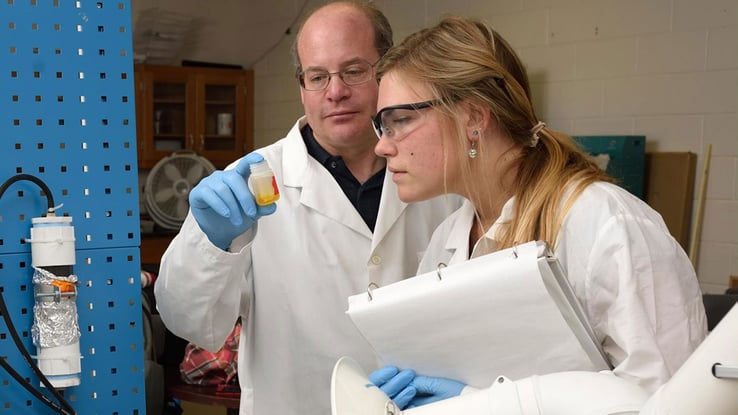 research page image of two people studying in a lab
