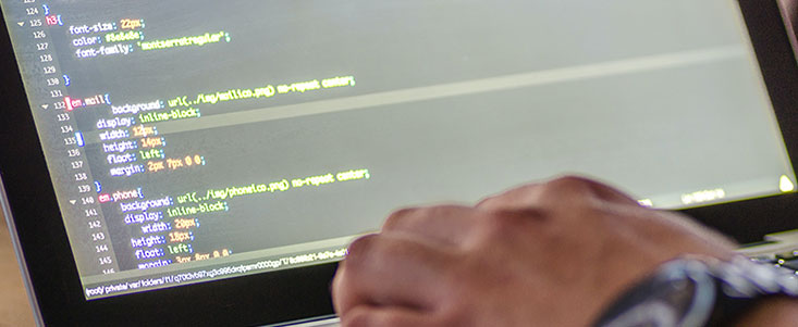 close up of a hand writing code