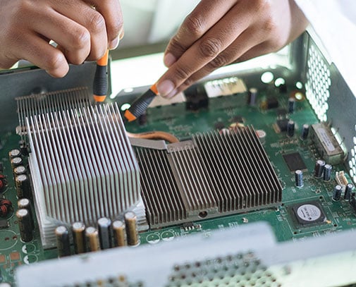 Close up inside a computer, hands navigating through it with tools