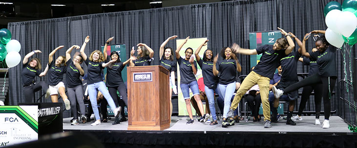 CoRe Ambassadors performing a dance on stage during the Colloquium event.