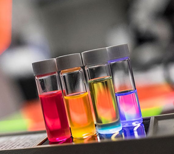 Vials full of color that look like a rainbow placed next to each other