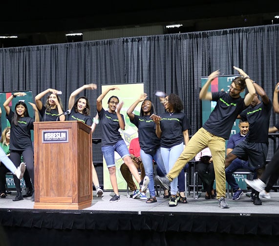 CORE student Ambassador dancings on stage during 2019 Colloquium