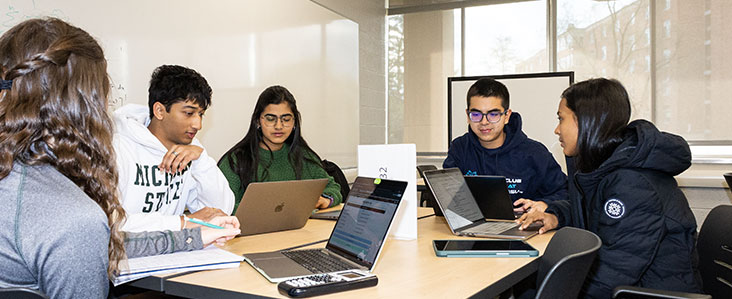Students around a table for tutor session