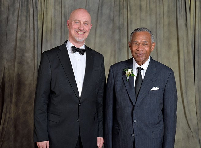 Essex E. Finney Jr. with another person at a coat and tie event